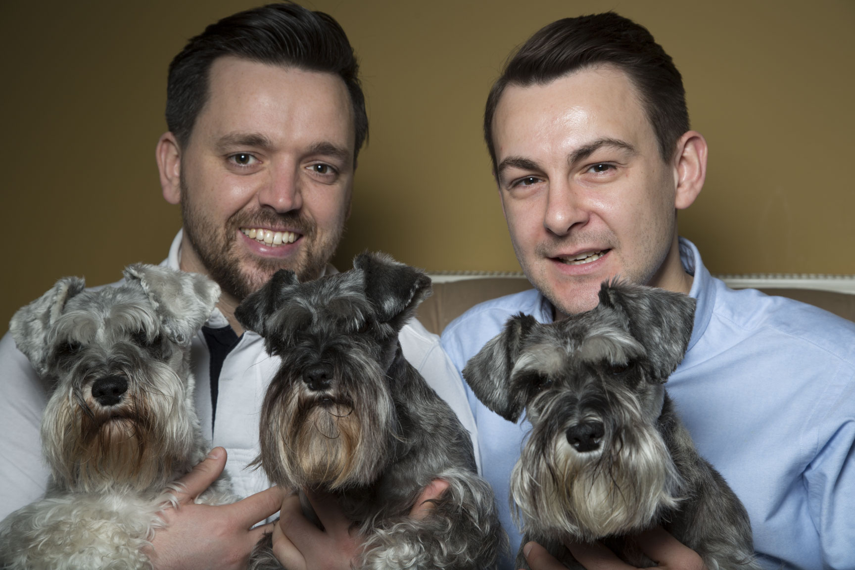 Rob and Bob, TACT foster carers since 2024, holding their dogs