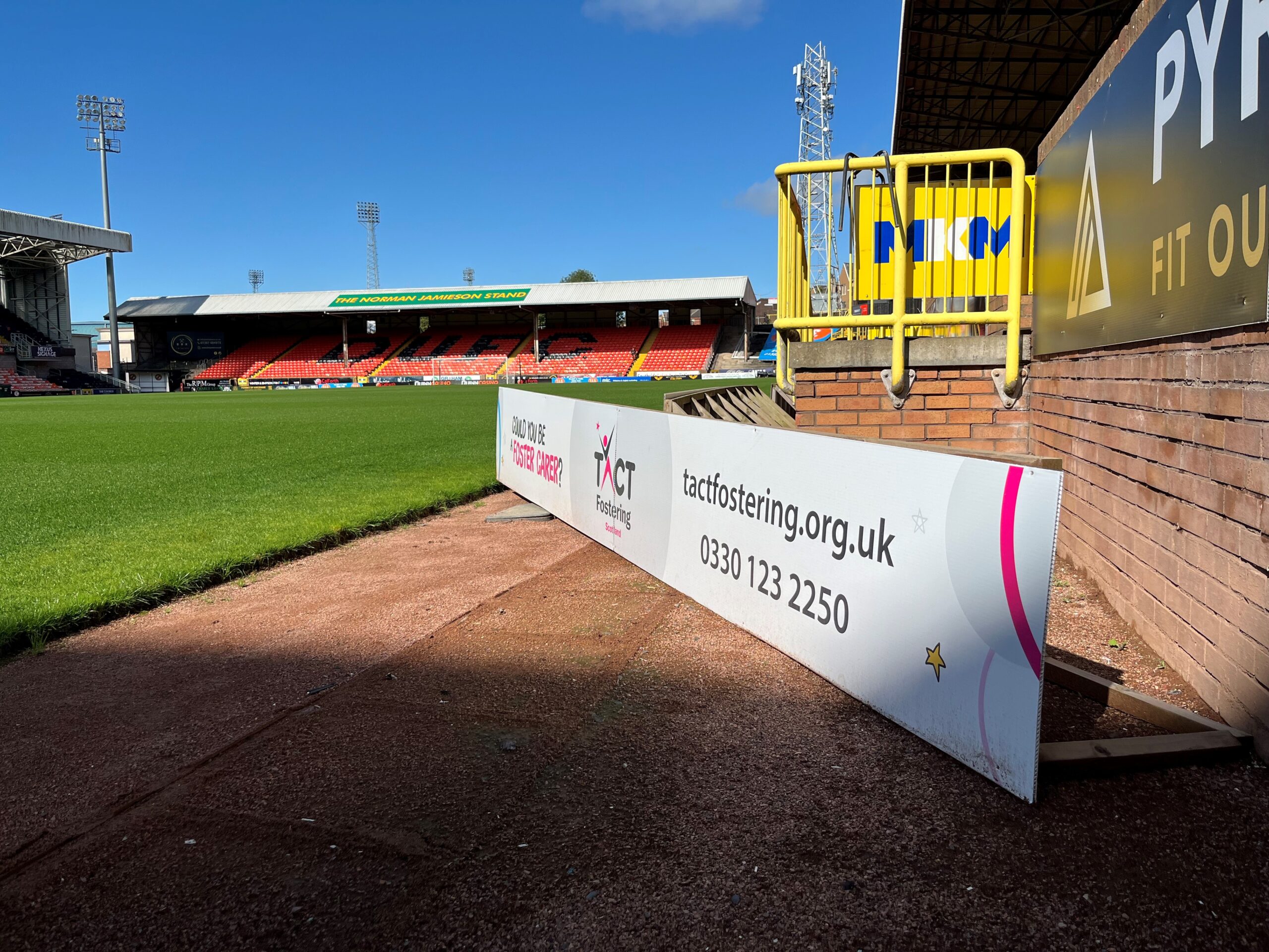 The TACT banner with the pitch in the background