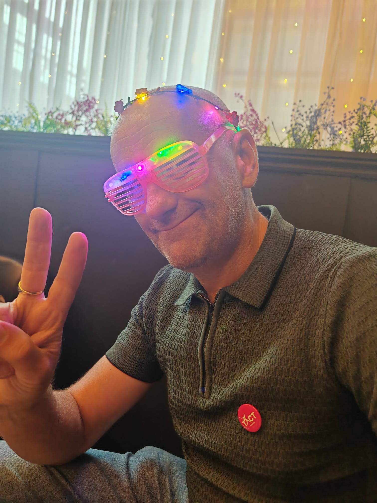 A TACT foster carer wearing flashing glasses at a wellbeing event