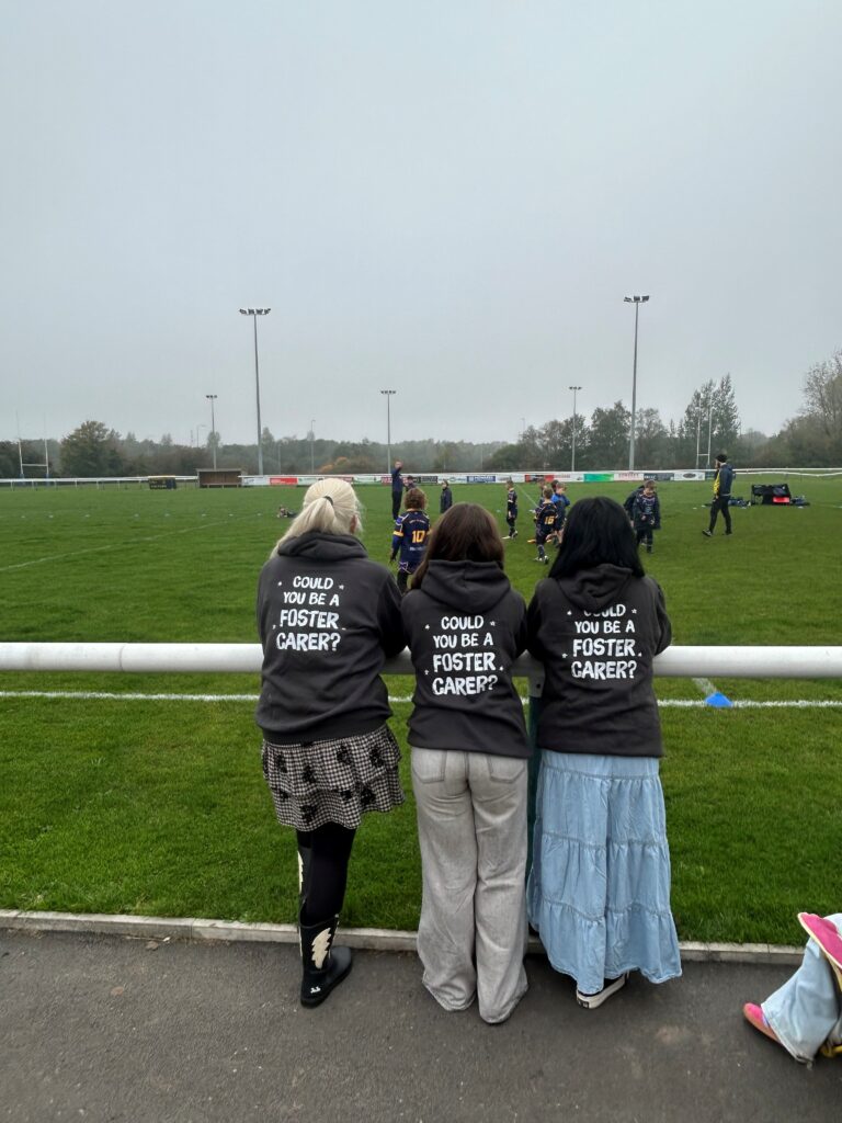 Three TACT staff watching Orrell St James ARLFC rugby team play