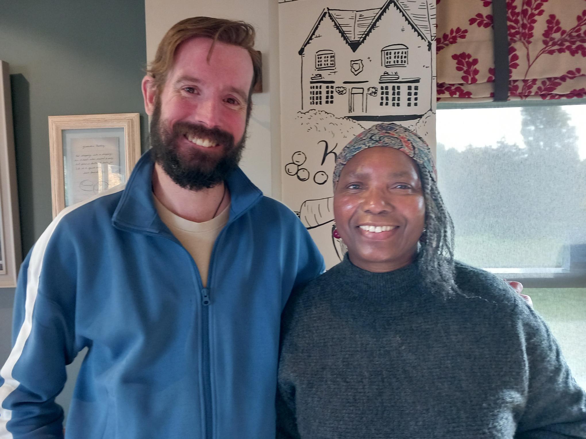Two TACT London and South foster carers smiling at a wellbeing breakfast