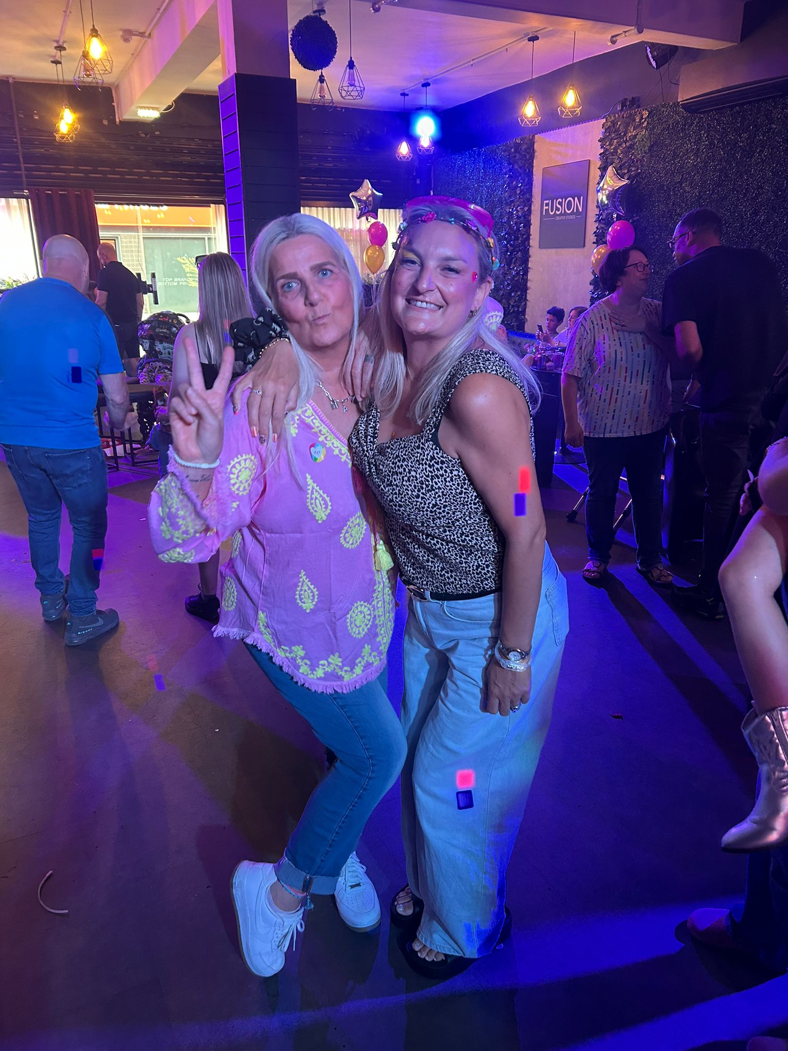 Two TACT foster carers posing at a north west wellbeing event