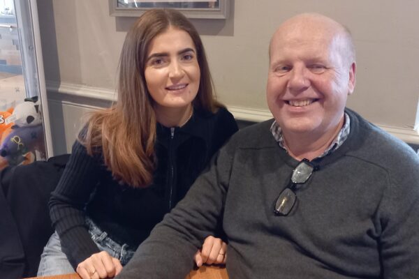 Two TACT foster carers smiling on one of our wellbeing events