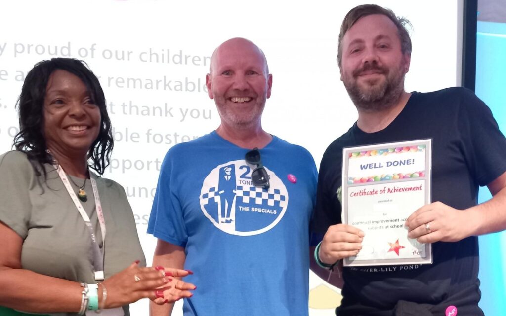 TACT foster carer, Steven, collecting an achievement award from Andy Elvin, on behalf of a young person