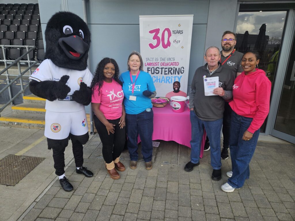 TACT staff and carers, along with the Raven mascot, supporting Bromley FC