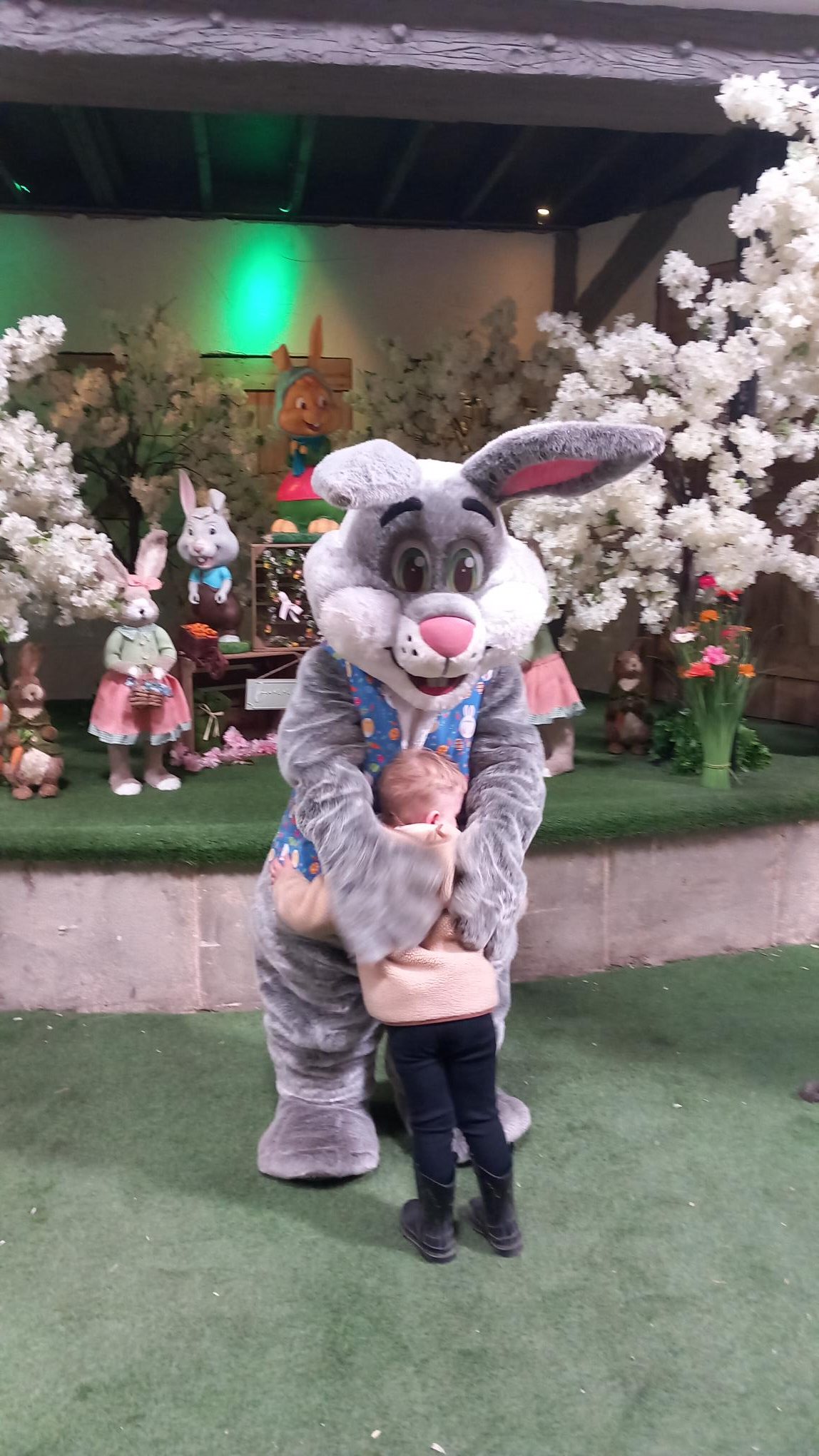 A TACT young person hugging the Easter Bunny at Farmer Teds