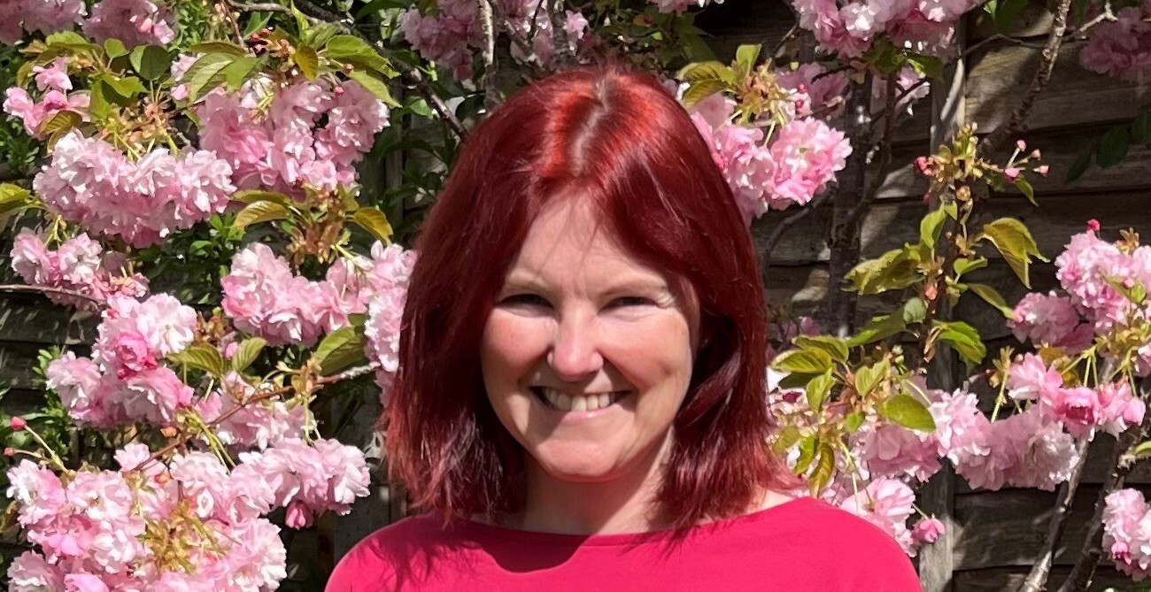 Ali, TACT foster carer, smiling in her garden