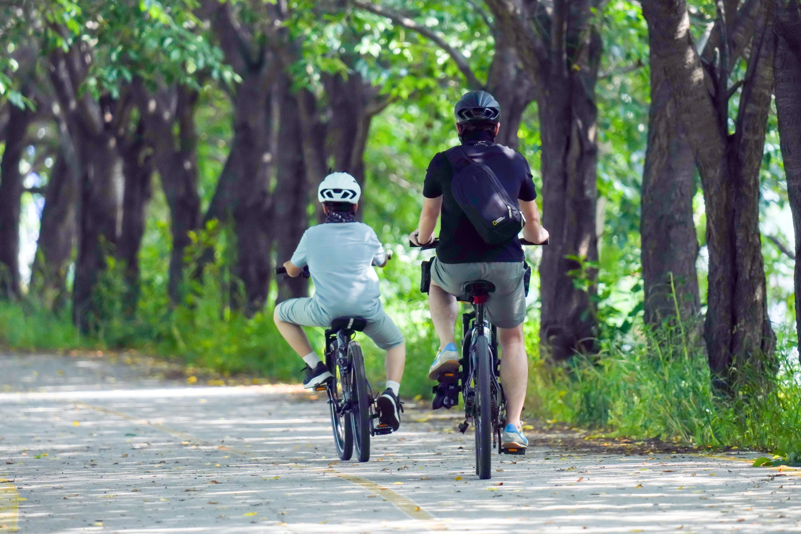 A foster carer and a child on bikes