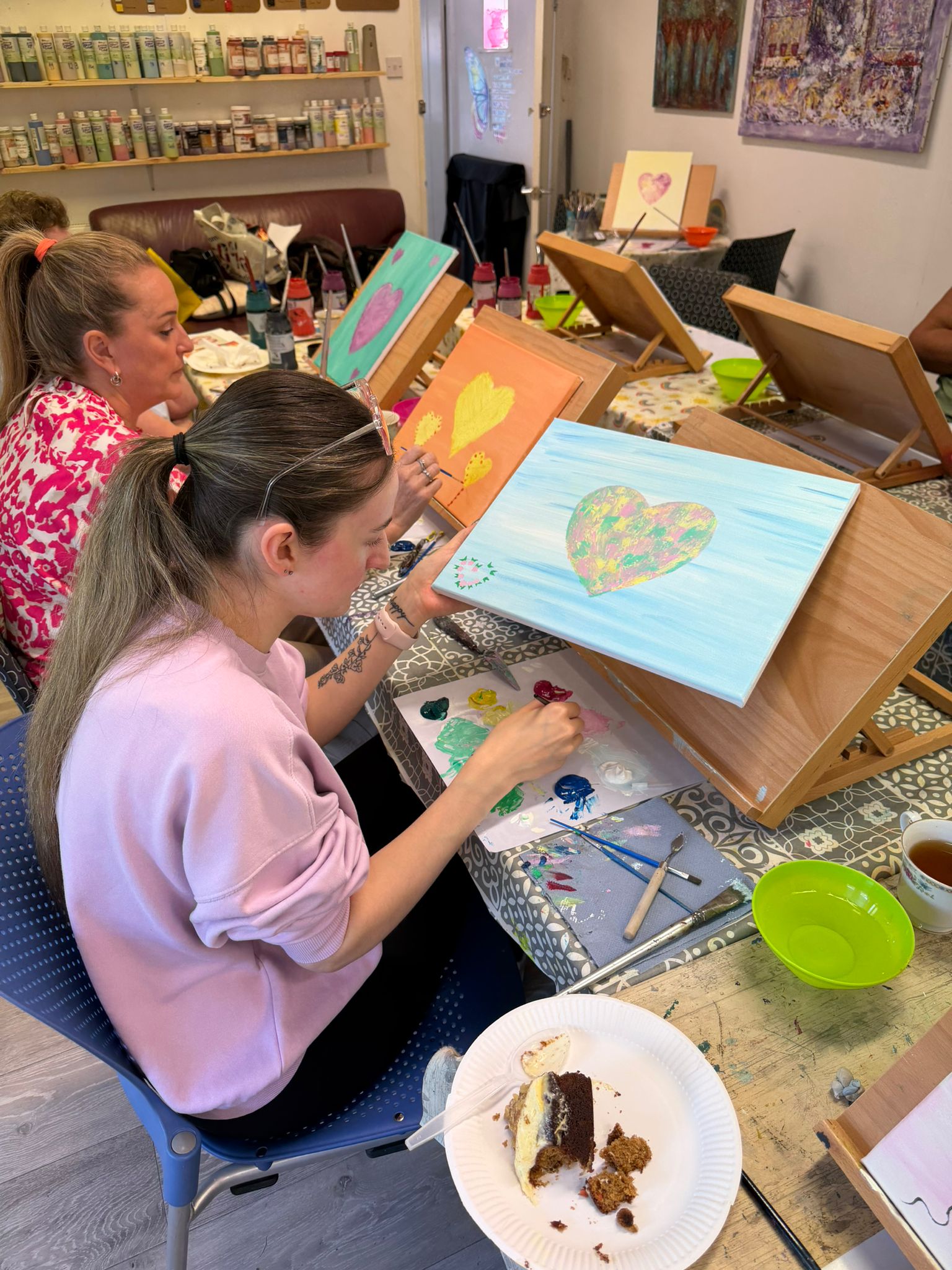 A TACT foster carer putting the finishing touches to her heart painting