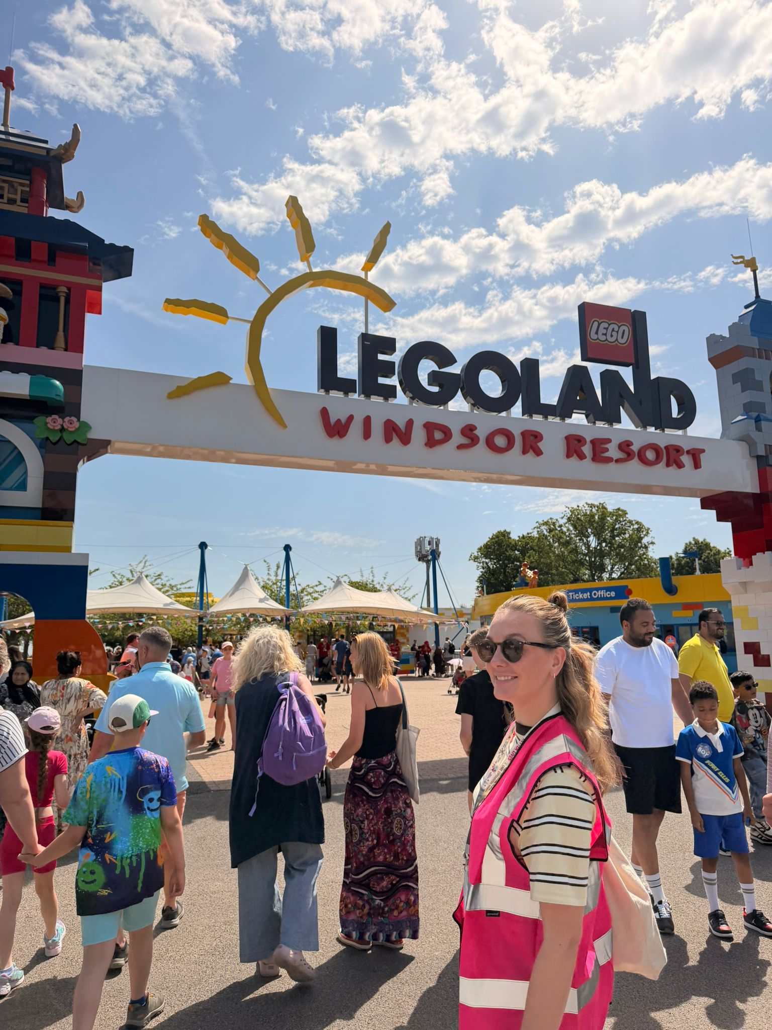One of TACT's Engagement and Activity Practitioners smiling at the Legoland entrance