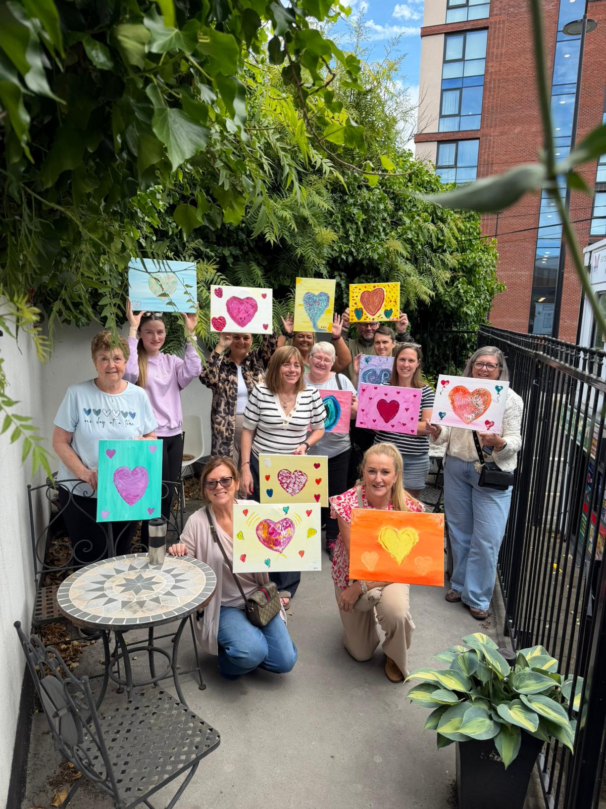 TACT foster carers showing their finished art