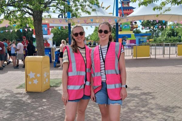 Two of TACT's Engagement and Activity Practitioners smiling at Legoland