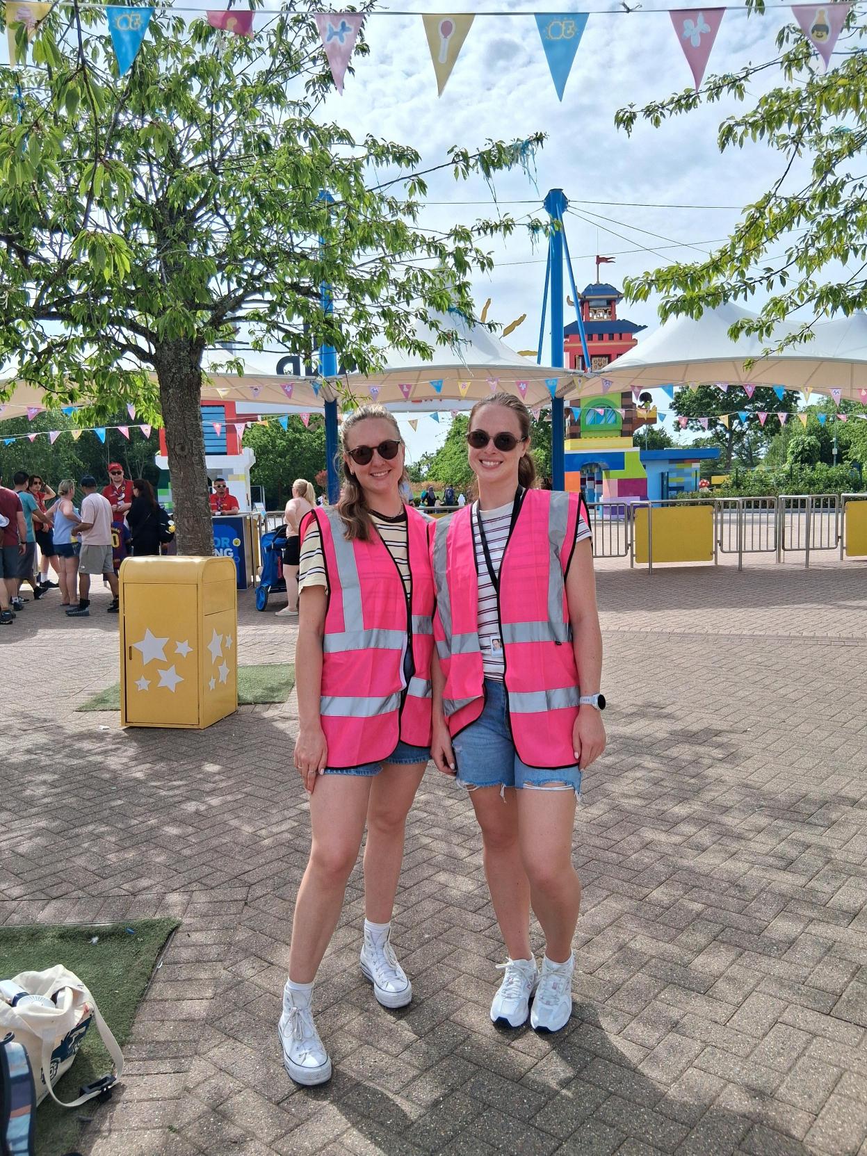 Two of TACT's Engagement and Activity Practitioners smiling at Legoland
