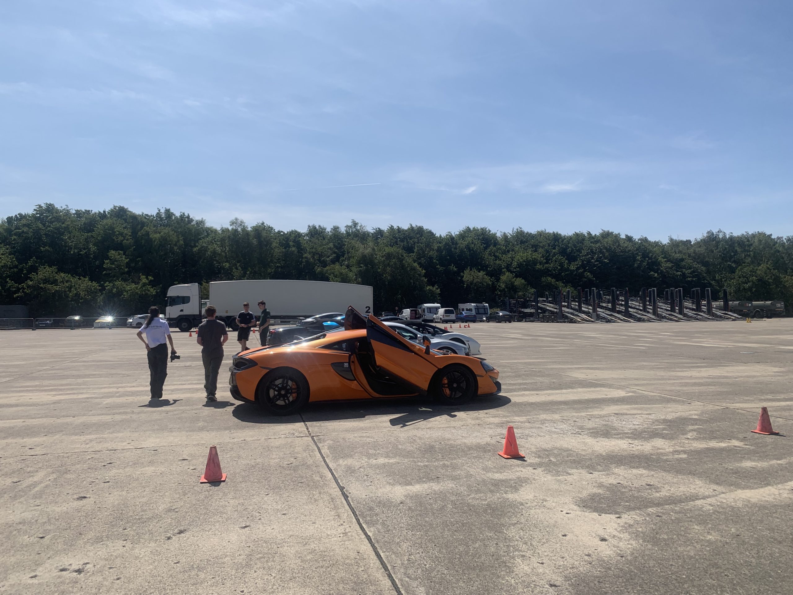 An orange sports car being prepared for driving