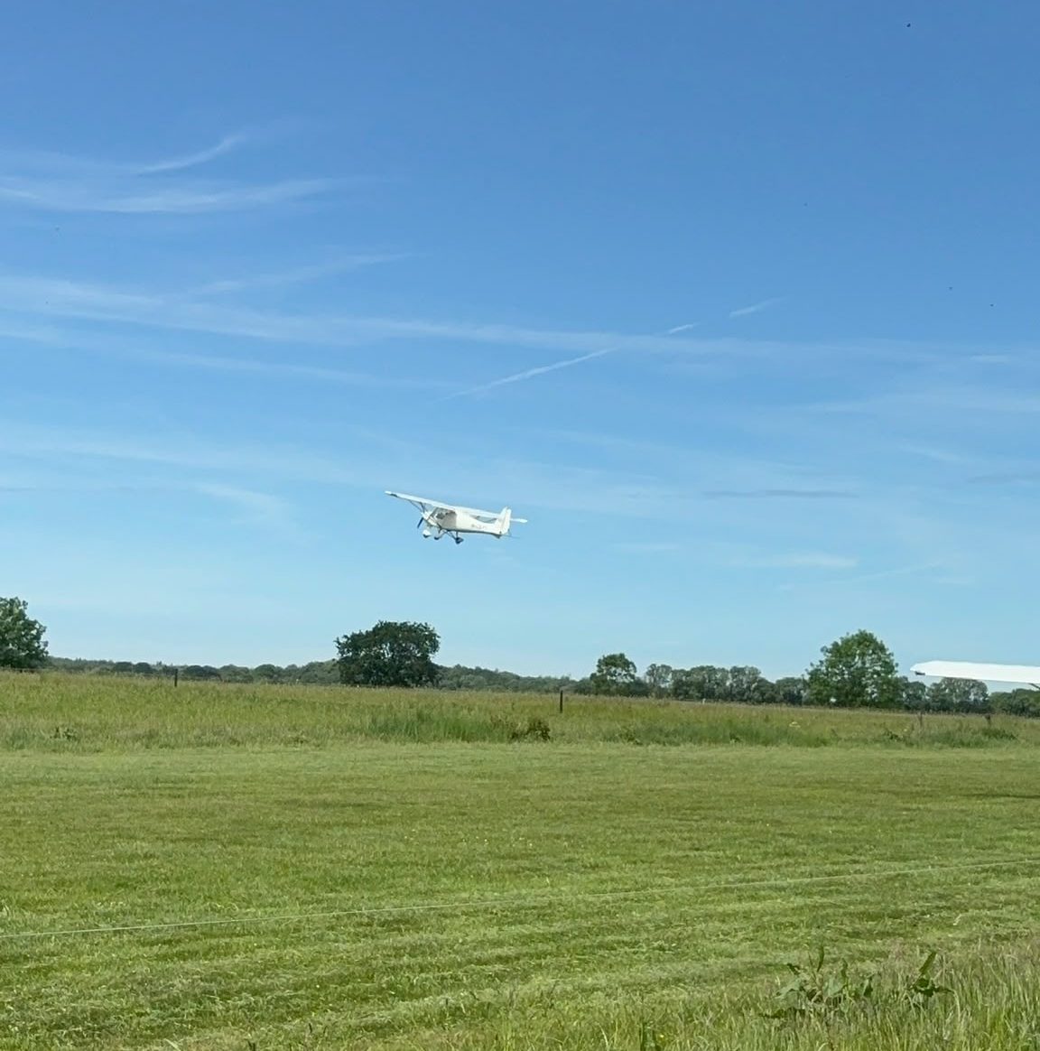 A plane taking off over a field