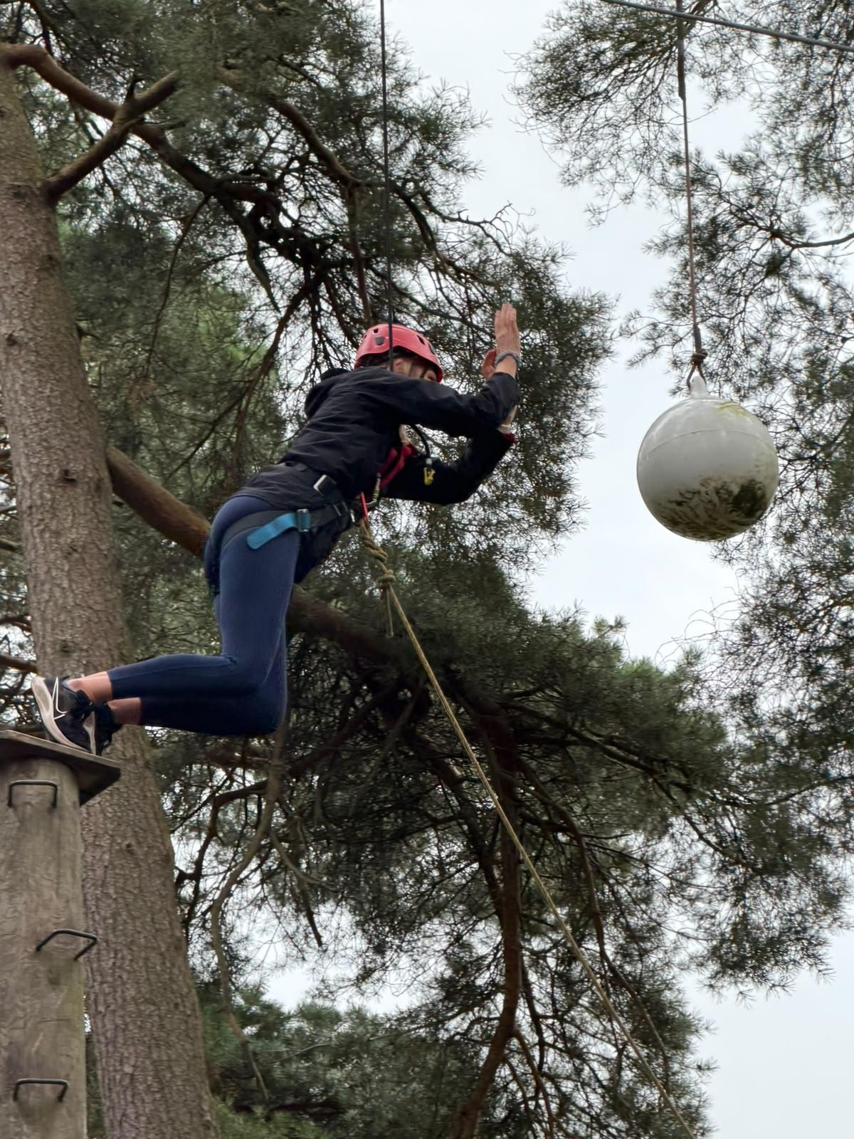A foster carer taking part in a leap of faith activity