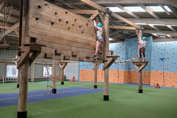 A TACT young person on a climbing wall
