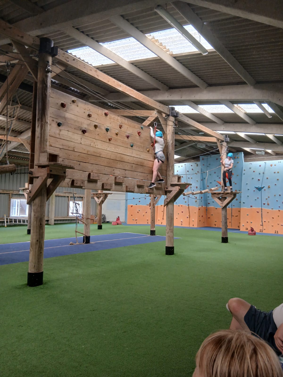A TACT young person on a climbing wall