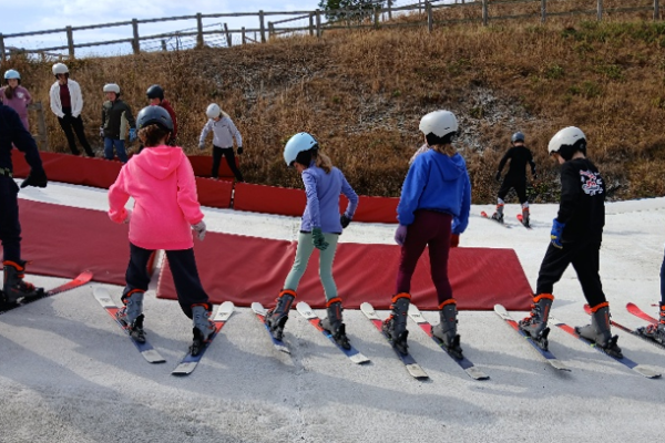 Four young people getting ready to ski