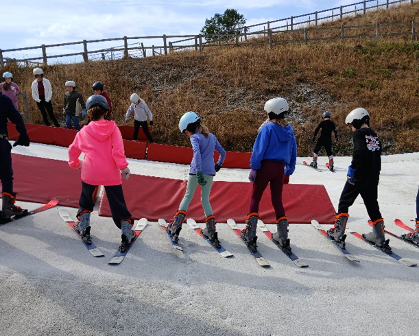 Four young people getting ready to ski