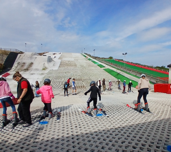 Some young people looking at a ski slope