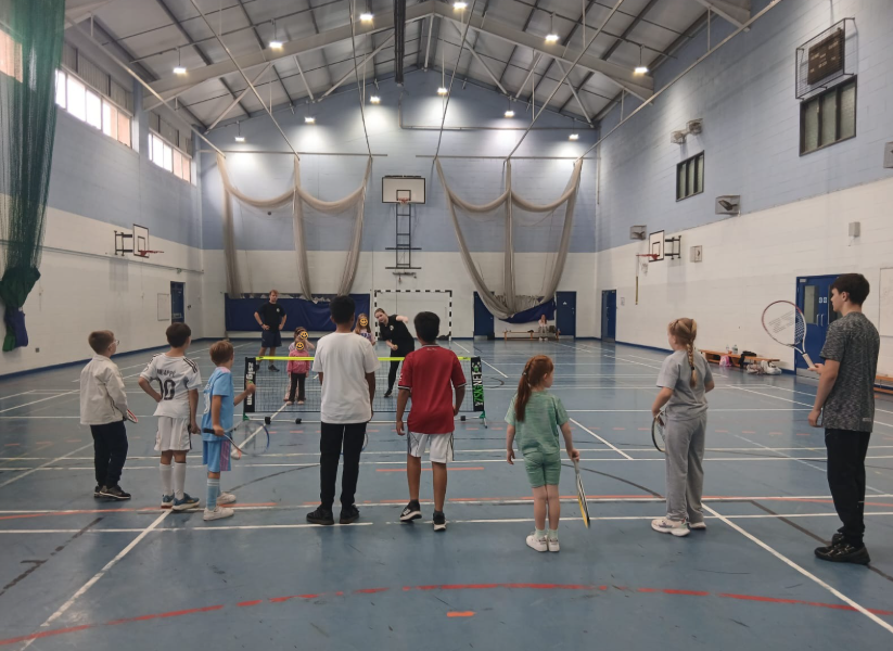 Young people stood preparing to play tennis