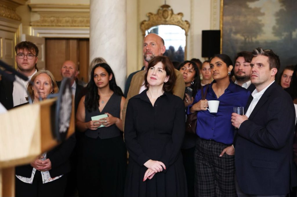 Guests at 10 Downing Street listening to a speaker
